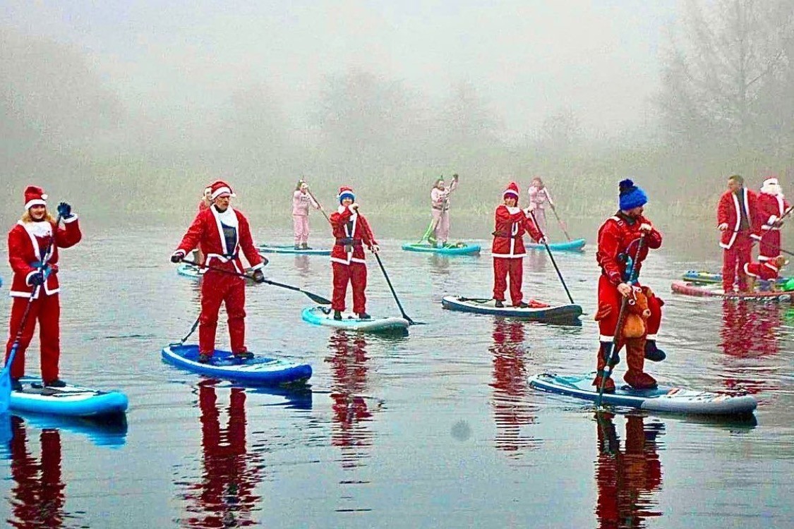 Santas make a splash. Photo: Matthew Hurding / Glasgow Paddleboard Co