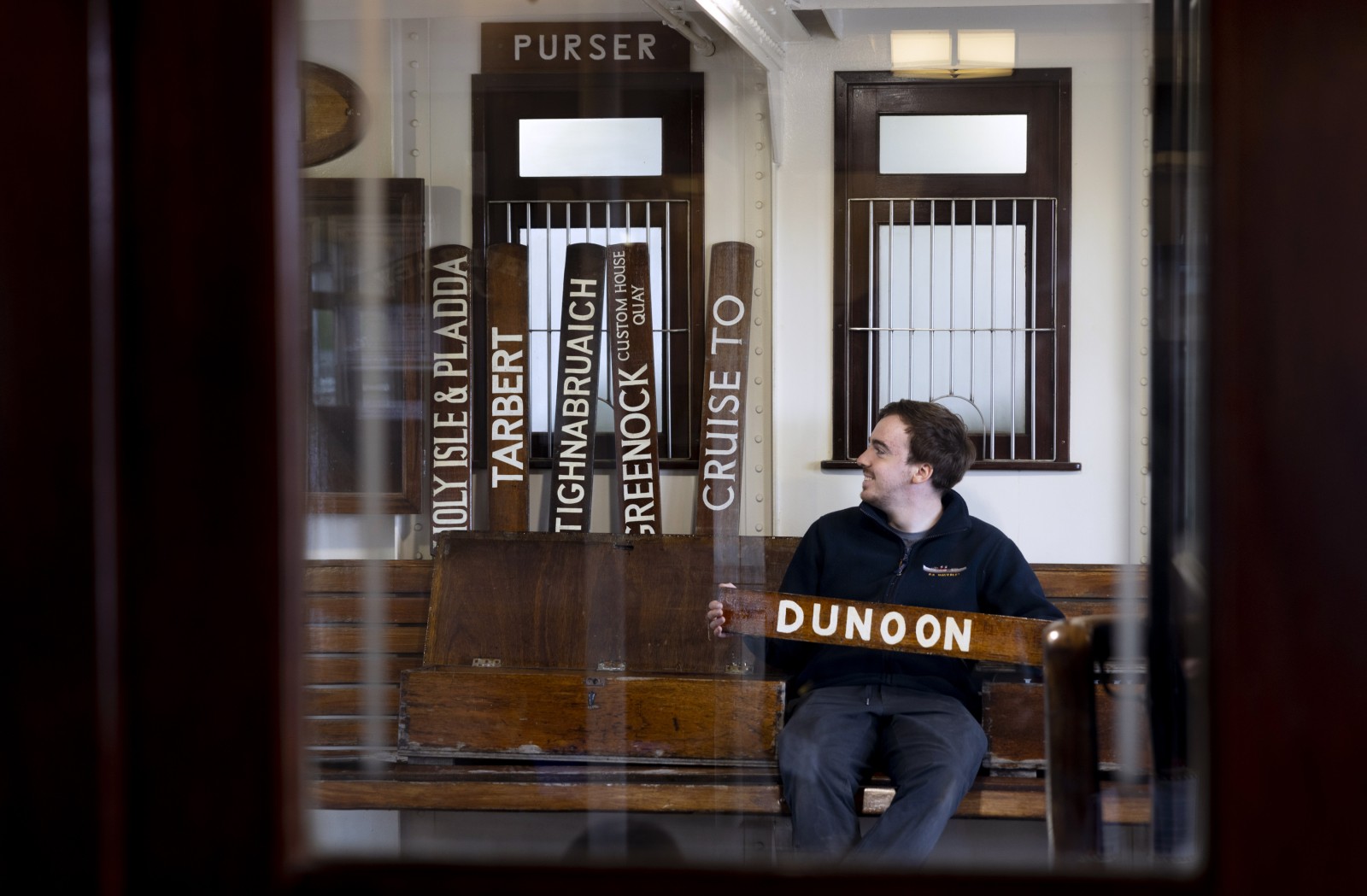 Purser Andrew Comrie prepares destination boards ahead of the ship's jubilee season. Photograph: Martin Shields