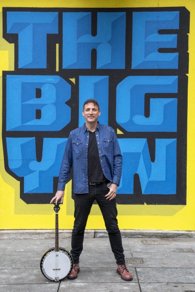 Scottish Musician Gary Innes in front of Billy Connolly 'The Big Yin ' mural , Royal Exchange Square, Glasgow  Picture: Photo credit: Not specified, supplied by Hoolie in the Hydro
