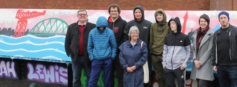  CAPTION: Councillor Michael Cullen is pictured with some of the young people who completed the mural as well as Jordan McGrotty and Arthur McNeaney of DRC Youth Project, representatives of the Heart of Scotstoun Community Centre and Karen Venables of Community Safety Glasgow 