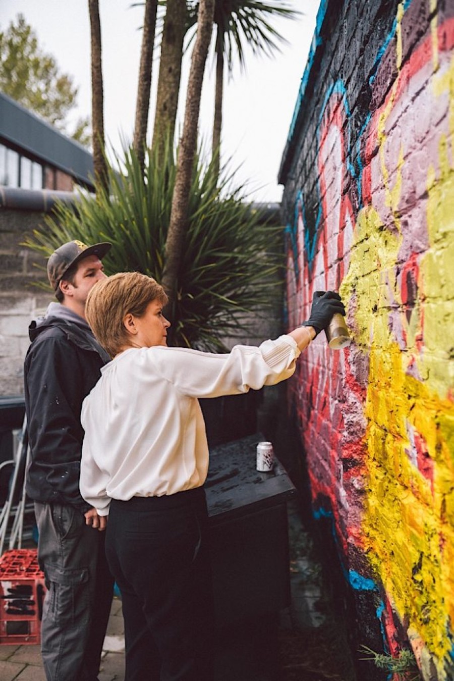  The first minister tried her hand at spray painting during her visit