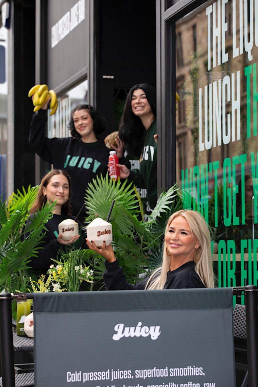 Pictured Fallon Carberry enjoying a Juicy Coconut with staff outside the new Byres Rd flagship store: Photo: Martin Shields