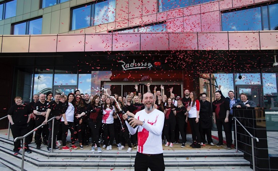  Curator Michael Weston with Team RED toasting the opening of Radisson RED Glasgow. Photo © Martin Shields
