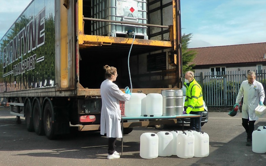  Joanne taking delivery of the high-strength alcohol.
