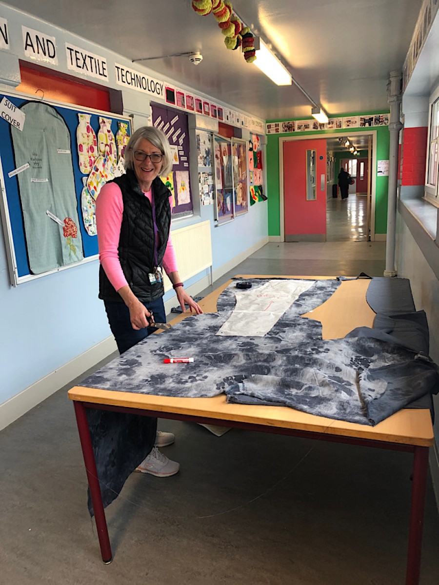  Teacher Shirley McIlroy cutting out shapes in the school corridor. Photo: Kay Muir