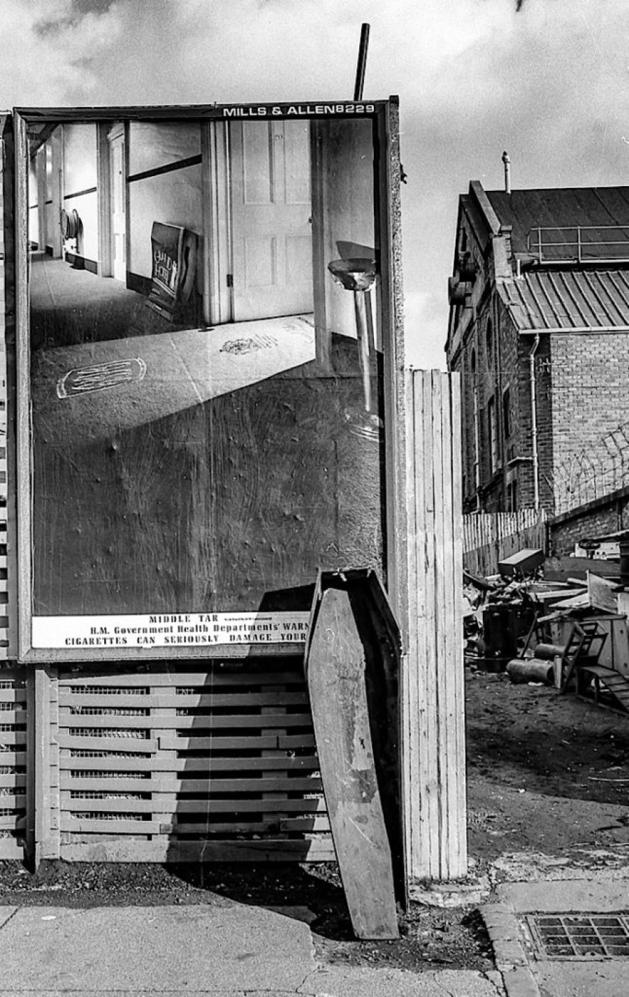  A bit of humour captured on film. A coffin propped up against a tobacco advert.