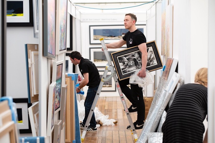  Award-winning Glasgow-based artist Ryan Mutter with some of his work depicting the Glasgow shipyards. Photo: Martin Shields