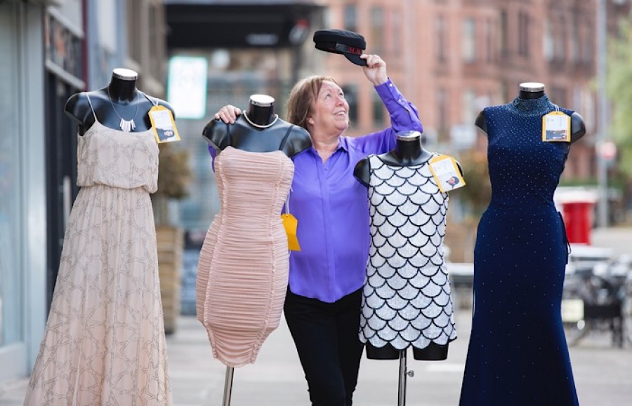  Kathy Murdoch, Buchanan Galleries general manager, with a selection of celebrity designer dresses available to buy at Marie Curie ladies evening. Photo: Martin Shields