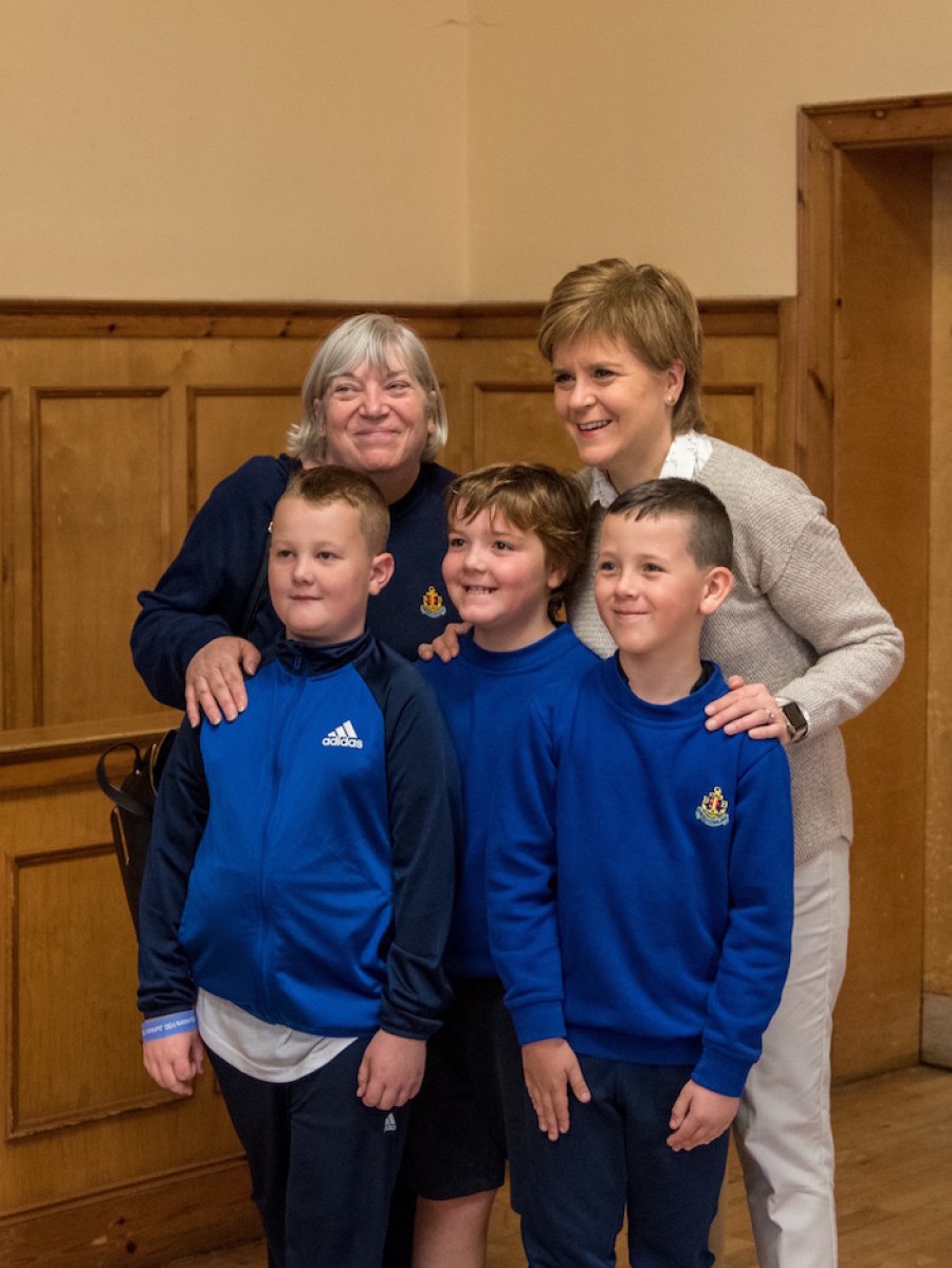  Smile: Ms Sturgeon helps the boys achieve their task of being photographed with a politician. Photo credit: Stuart Buchanan
